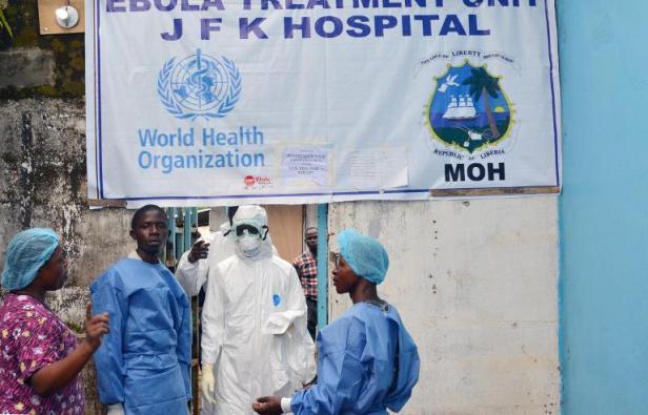 648x415_personnels-sante-posent-devant-centre-traitement-malades-ebola-john-f-kennedy-medical-center-monrovia-13-octobre-2014