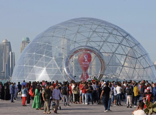 Feature image Des personnes rassemblées près de l'horloge marquant le compte à rebours avant la Coupe du monde de football, à Doha au Qatar, le 30 mars 2022, crédit photo AFP