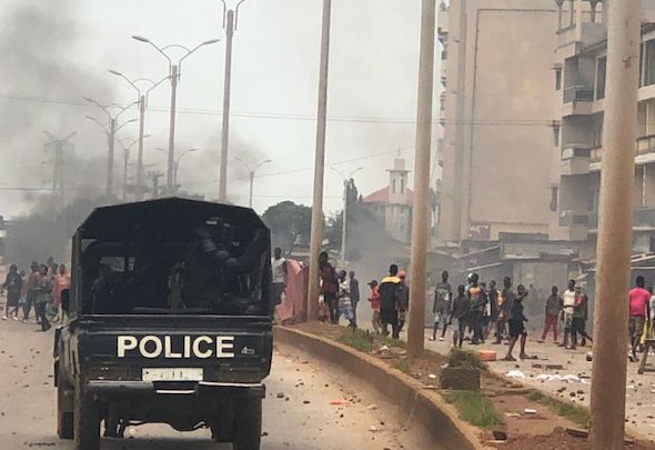 Un véhicule de la police face à des manifestants sur le tronçon Cosa-Koloma