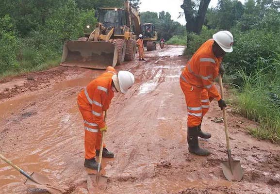 Des travailleurs de Winning Consortium Simandou réparant une route reliant le port fluvial de Morebaya à la commune rurale de Maférinya